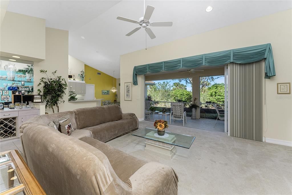 A wall of sliding glass doors leads to the private lanai overlooking a private backyard