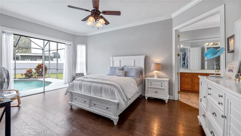 Primary Bedroom on first floor with sliding glass doors leading to pool.