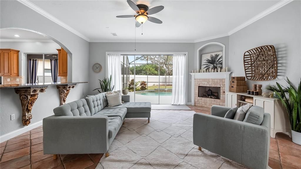 Family Room with fireplace and sliding glass doors leading to pool.