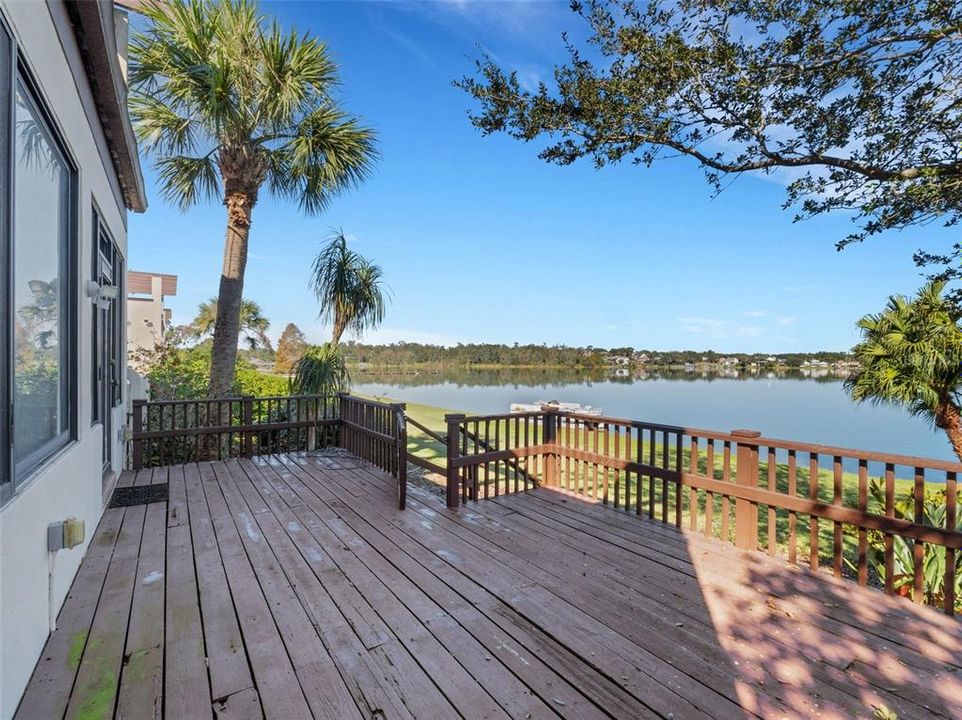 with steps leading down the backyard and waters edge beyond.