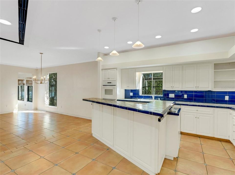 The large island kitchen becomes the center of the home.