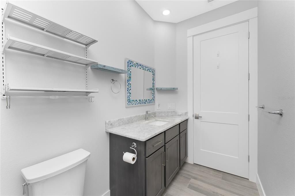 Guest Bathroom with door to Pool/Lanai (Pool Bath)