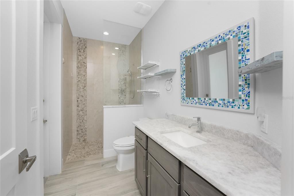 Guest Bathroom with door to Pool/Lanai (Pool Bath)