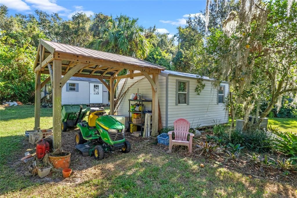 Shed, covered storage and second shed behind