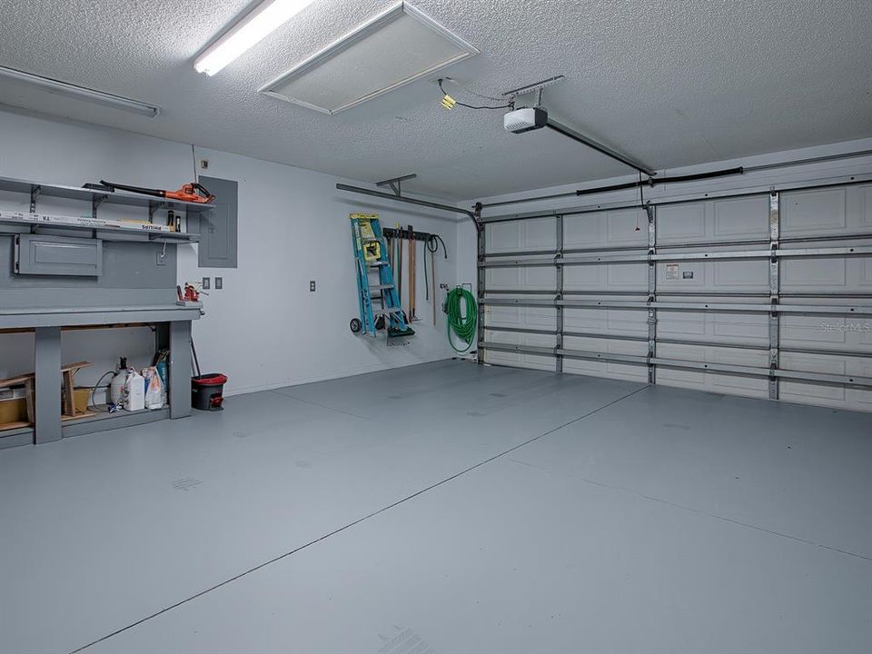 2 CAR GARAGE WITH NEW EPOXY FLOORING AND A WORKBENCH.