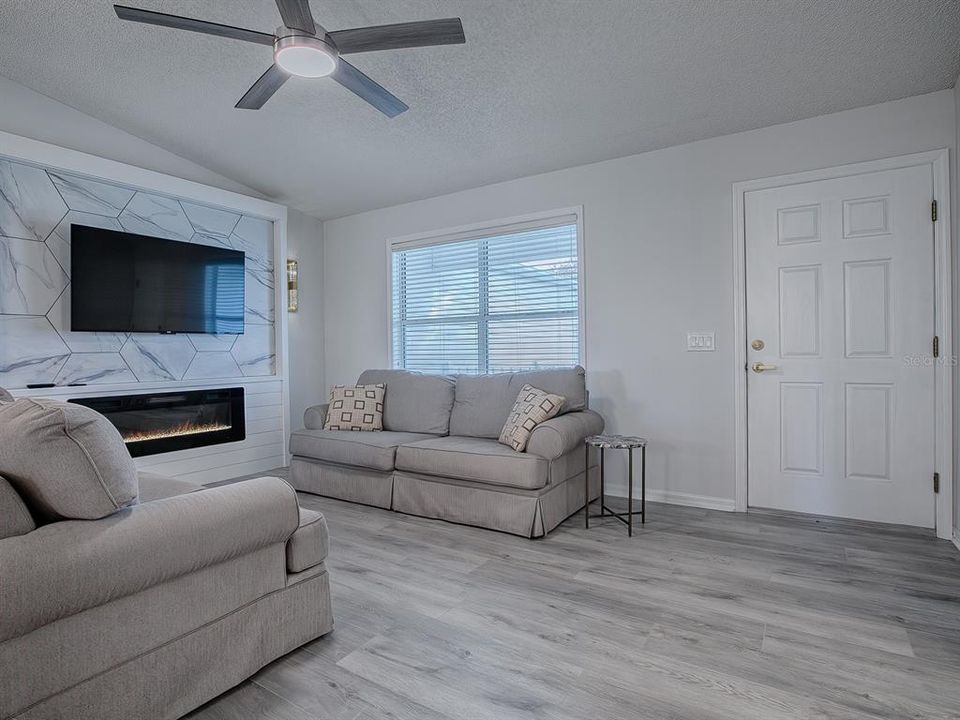 LUXURY VINYL PLANK FLOORING THROUGHOUT LIVING AND DINING AREA, KITCHEN, AND LAUNDRY ROOM.