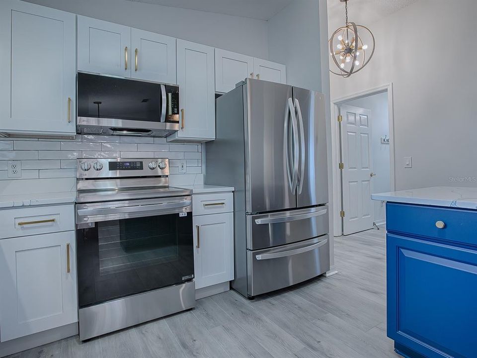 NEW STAINLESS APPLIANCES - EVEN THE OVEN HAS AN AIR FRYER!  THE OPEN DOOR LEADS TO THE INSIDE LAUNDRY ROOM.