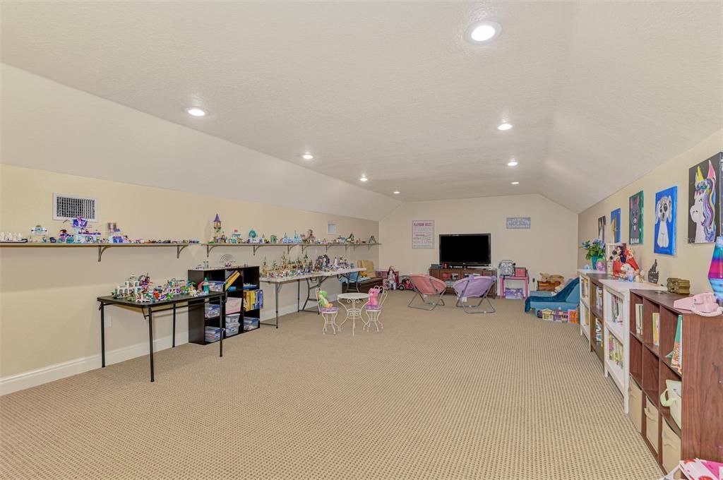 Upstairs bonus room used as playroom or media room.