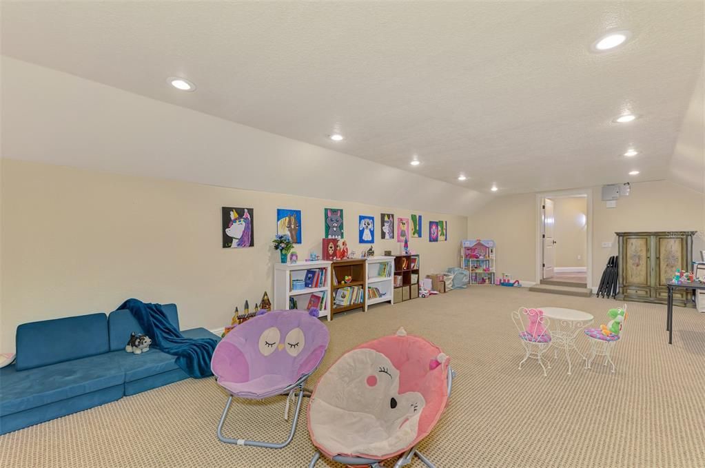 Upstairs bonus room used as playroom or media room.