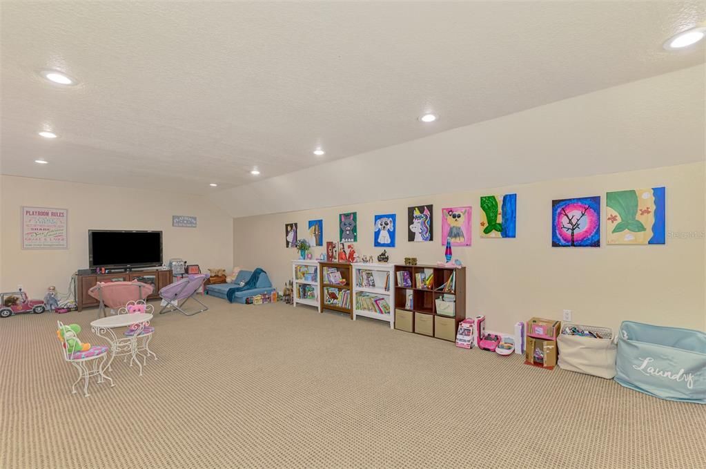 Upstairs bonus room used as playroom or media room.