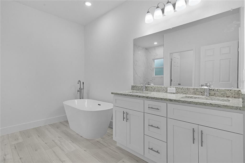 Primary bath with double sinks and glamour tub