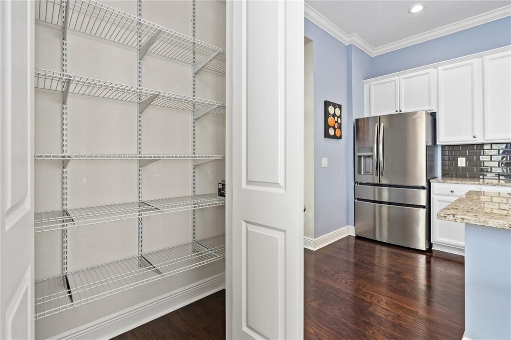 Kitchen pantry has heavy duty shelving for all your storage needs