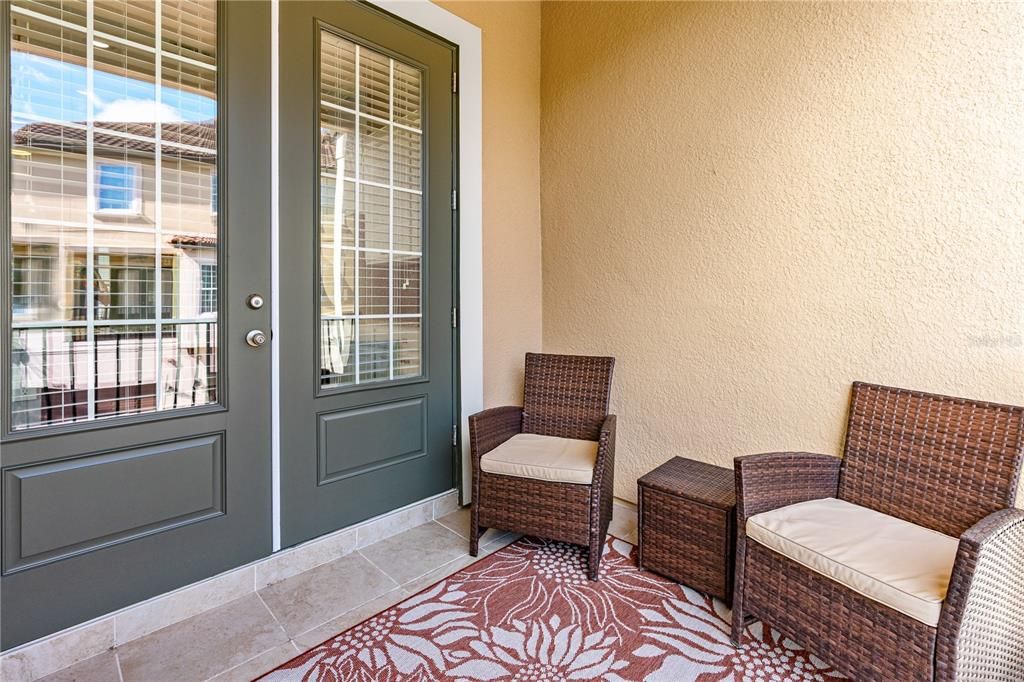 Private lanai off the kitchen extends the entertaining space; French doors have been freshly painted and new tile floor