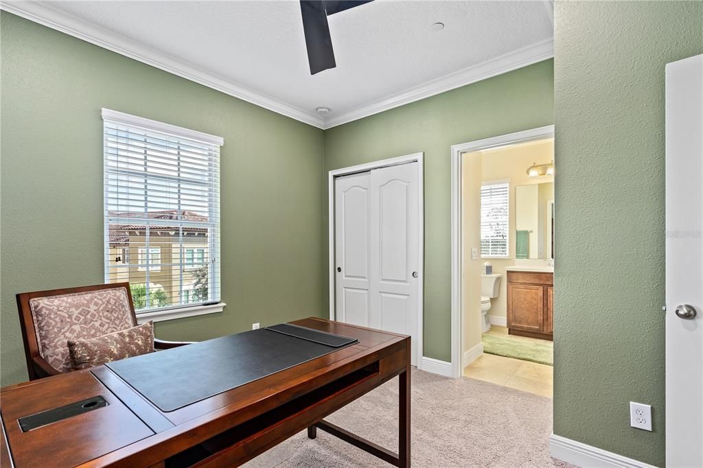 Bedroom 4 (currently being used as an office) with view toward Jack & Jill bathroom; Partner desk conveys