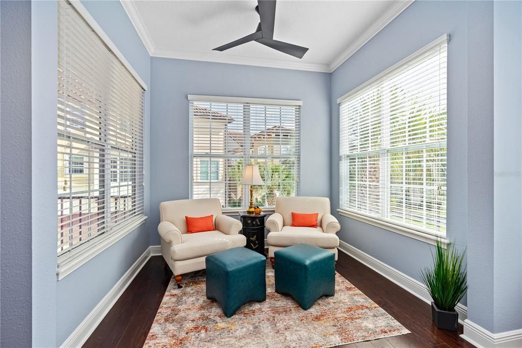 Sunroom/flex space with new ceiling fan is flooded with natural light