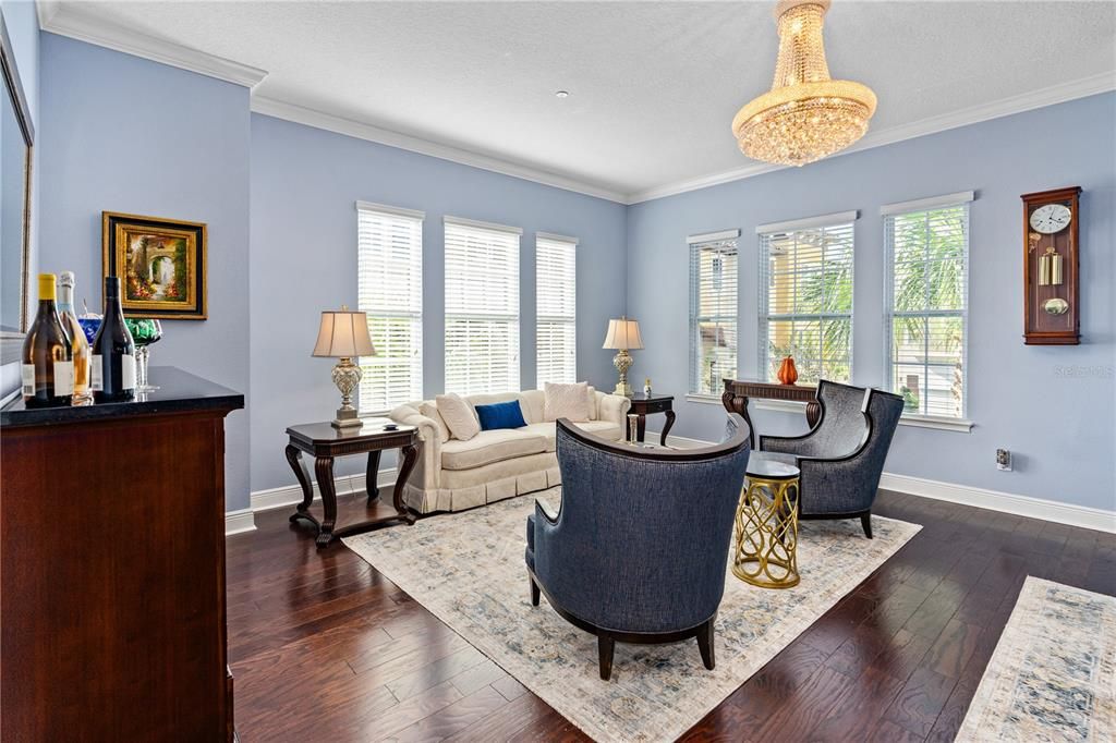 Living room offers tons of natural light from large windows plus a gorgeous new crystal chandelier