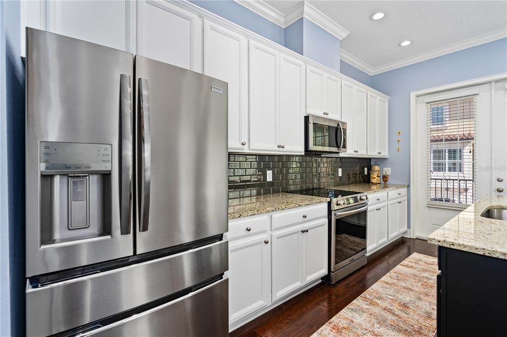 42" cabinets, all new upgraded stainless steel appliances, glass tile backsplash and granite counters