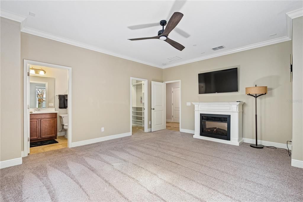 Flex space with view toward en-suite bath and large walk-in closet; Movable electric fireplace conveys