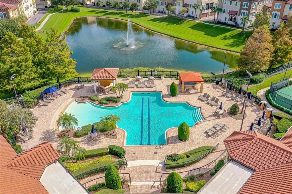 Clubhouse and pool area overlooking tranquil pond with fountain