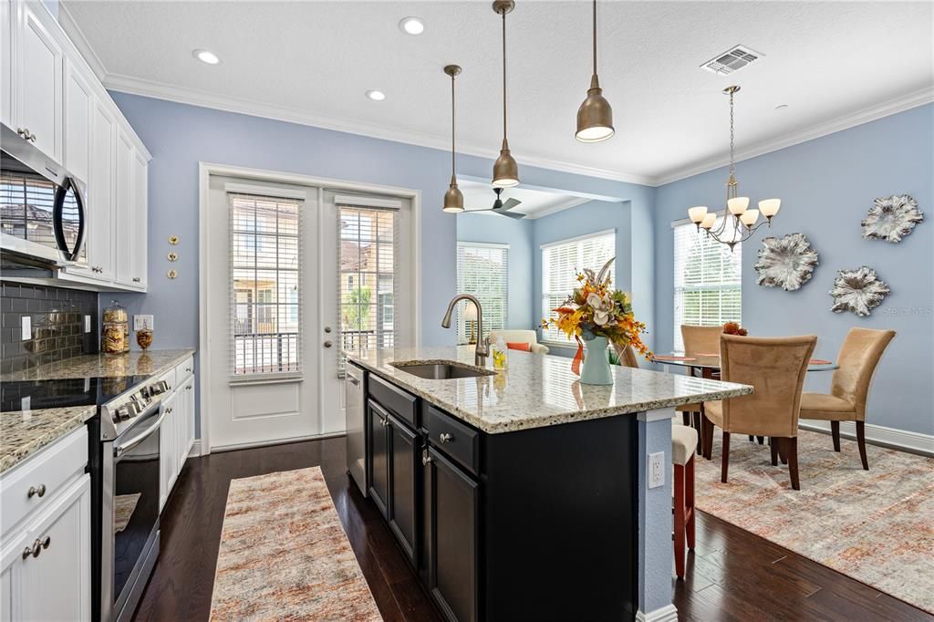 Large breakfast bar and accent pendant lights; French doors out to lanai