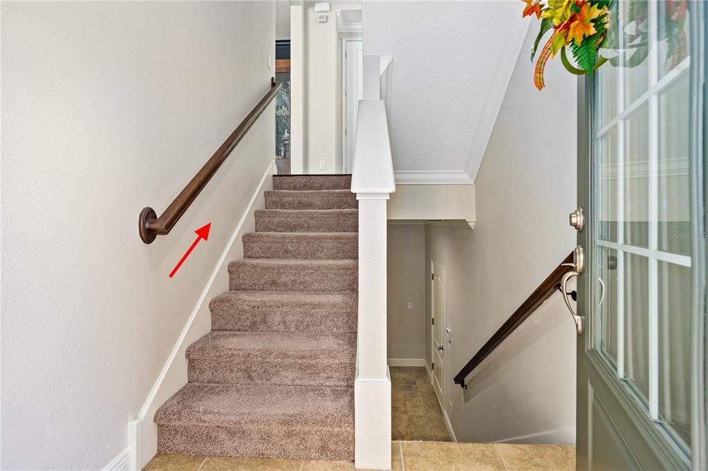 Stairs lead up to the kitchen, living/dining room and a half bathroom