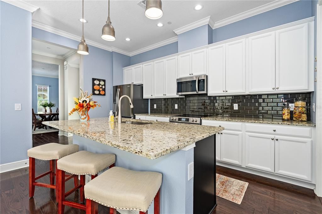 Stunning glass tile backsplash; Ample cabinet storage; Exterior vented exhaust fan