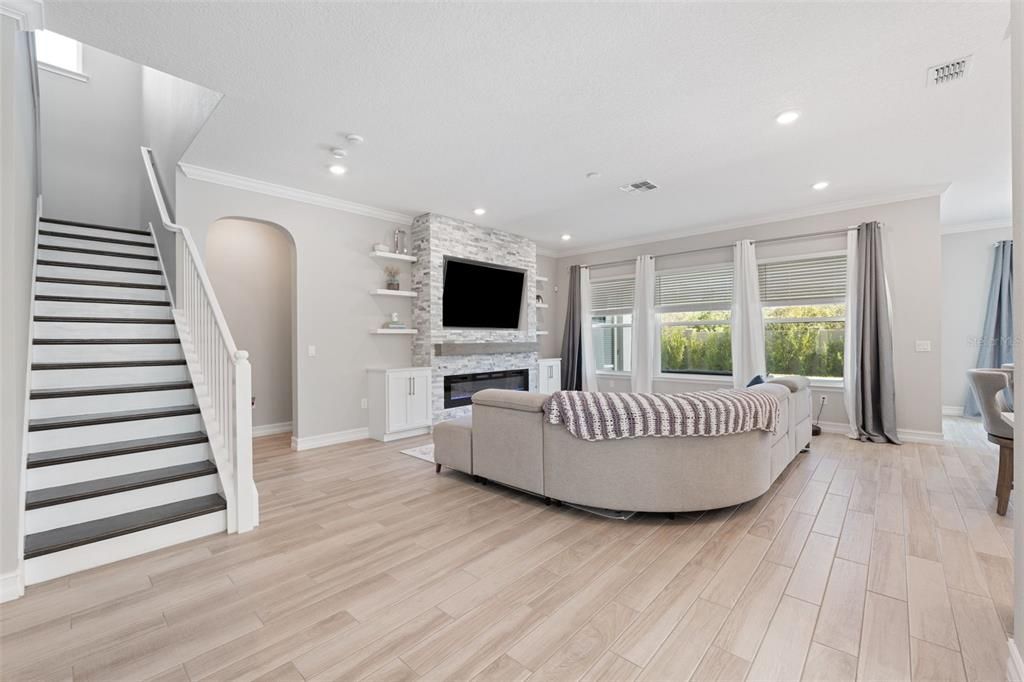 Spacious living room with custom built-in shelving and cabinets.