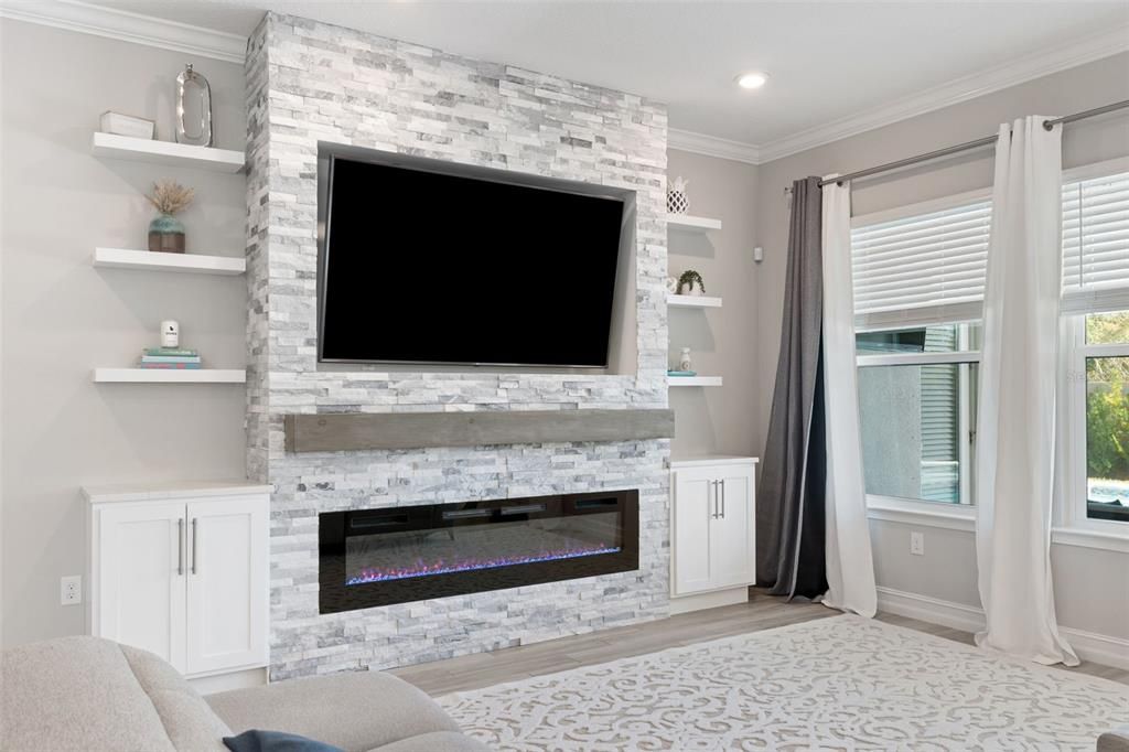 Custom built entertainment center with electric fireplace.