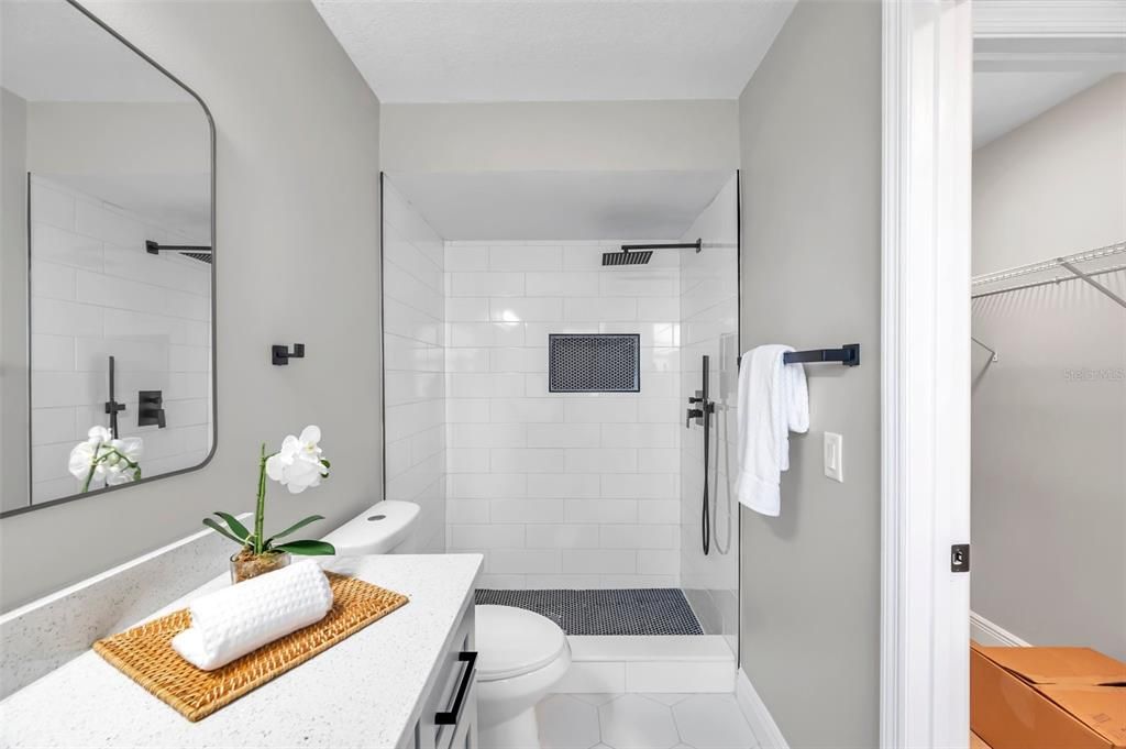 wly remodeled primary bathroom featuring a sleek walk-in shower and modern finishes, offering a spa-like retreat in your own home.