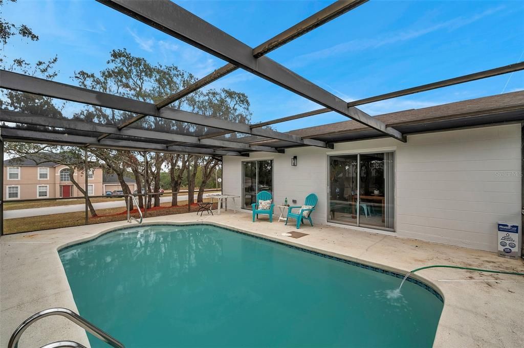 Step out from either of the two sliders to your private screened pool area—perfect for entertaining or a quiet retreat.