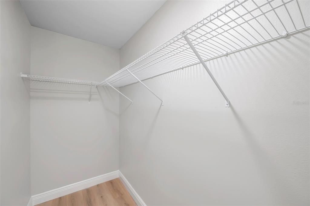 Spacious walk-in closet with ample storage, perfect for organizing and maximizing your wardrobe space.