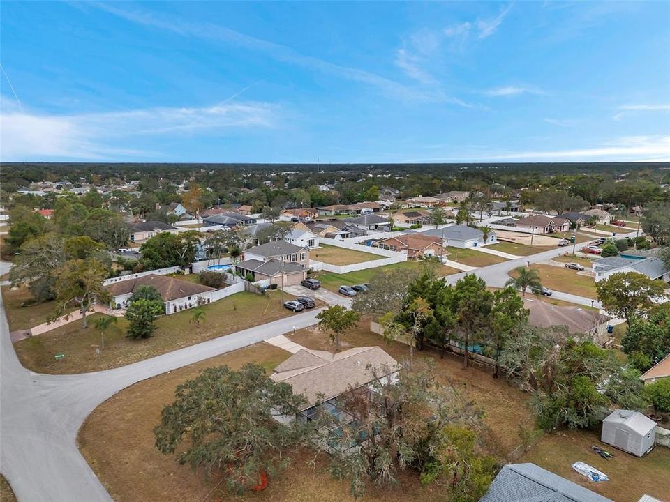 Large yard surrounding the home and pool, highlighted in this aerial view—perfect for entertaining, gardening, or play.