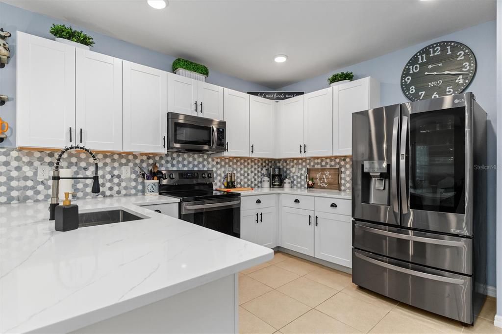 Beautiful quartz counters and marble backsplash