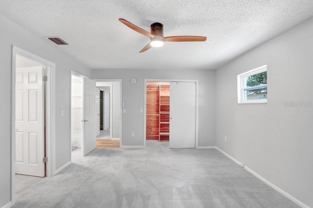 Primary bedroom with views of BOTH closets & the en-suite bathroom