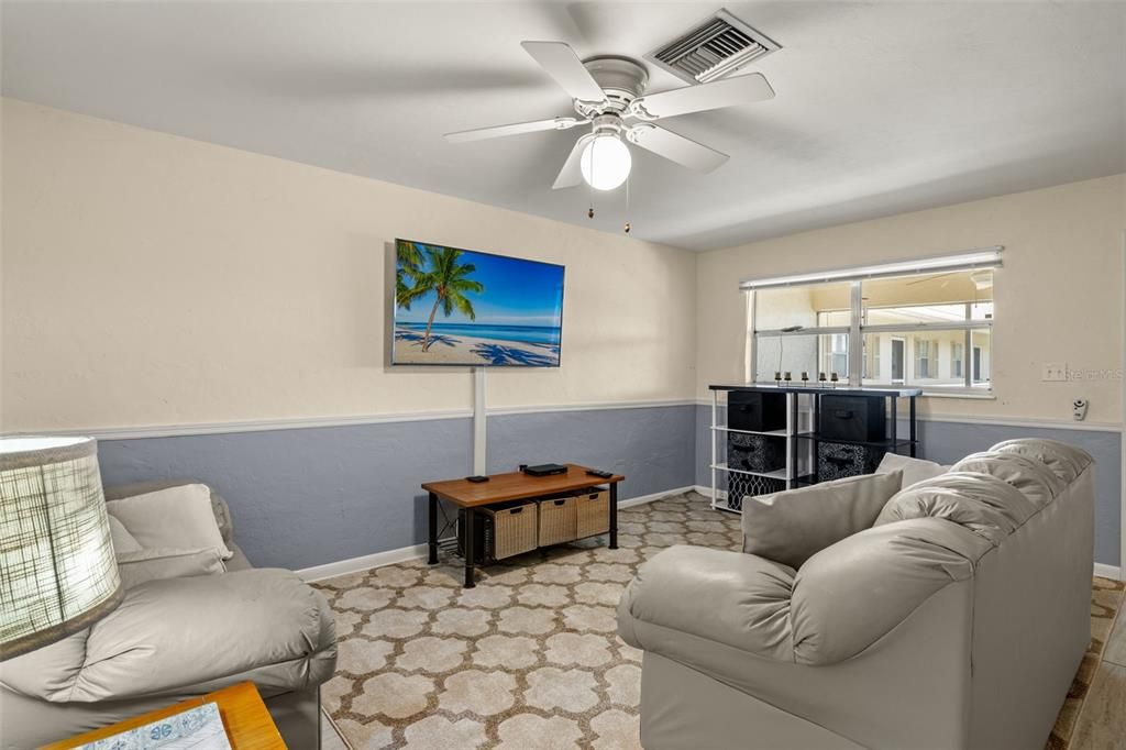 Living room overlooking the screened balcony and pool