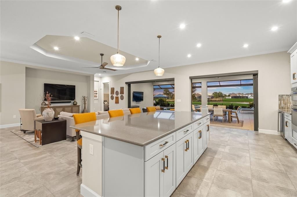 Custom Gourmet Kitchen with Soft Close Cabinets & Drawers, Oversized Island, Quartz Countertops, Range Hood, Gas Cooktop, Stainless Appliances, Farmhouse Sink, Wine Fridge, Wall Mounted Oven and Microwave, and eating space for a breakfast table if you so choose.