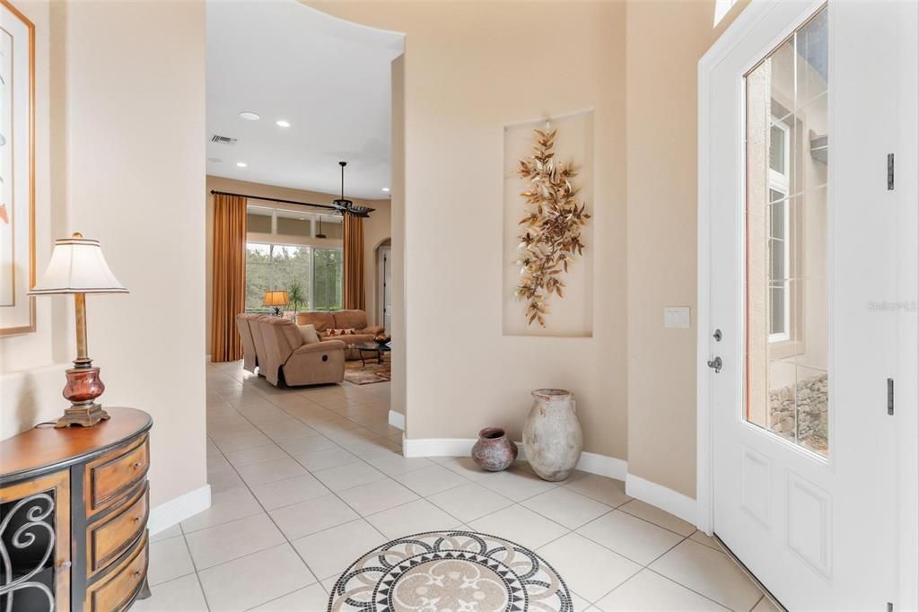 Foyer features custom floor with Mosaic Design & Niches for your Artwork!