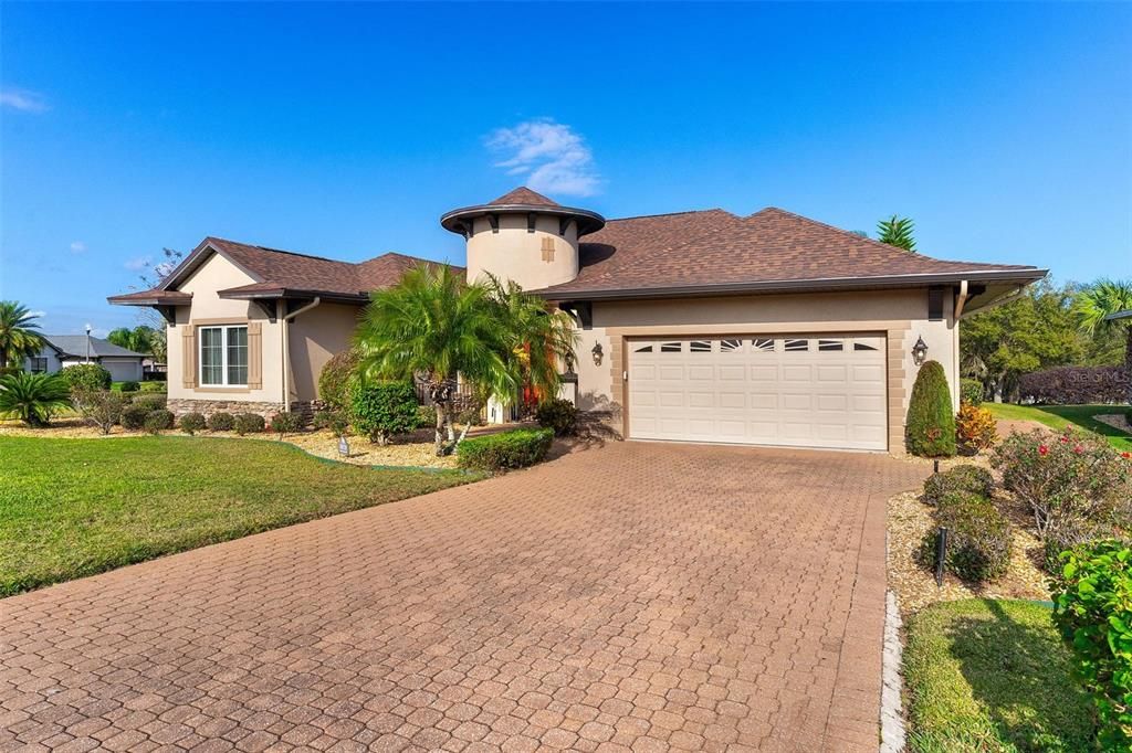 Brick paver driveway lead to 2 car garage and side golf cart entrance...