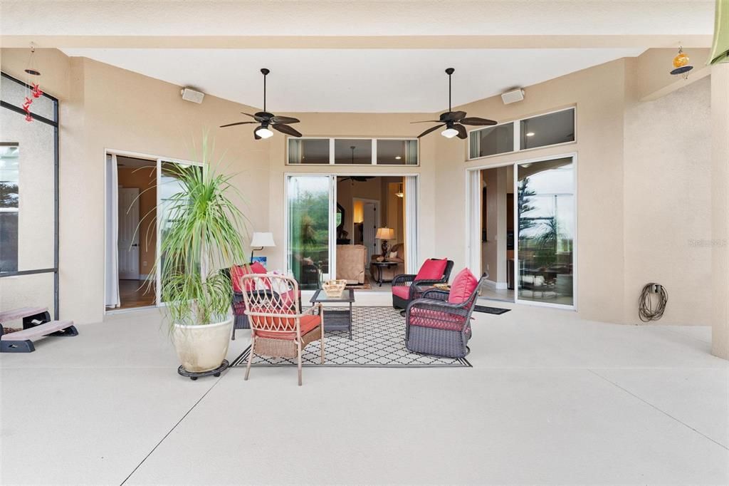 Triple set of glass sliding doors lead into home...