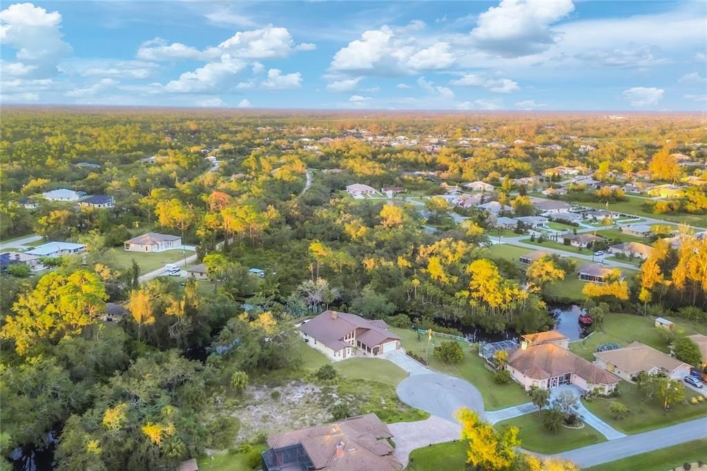 Aerial showing the home backing up to the river and mainly nature preserves.