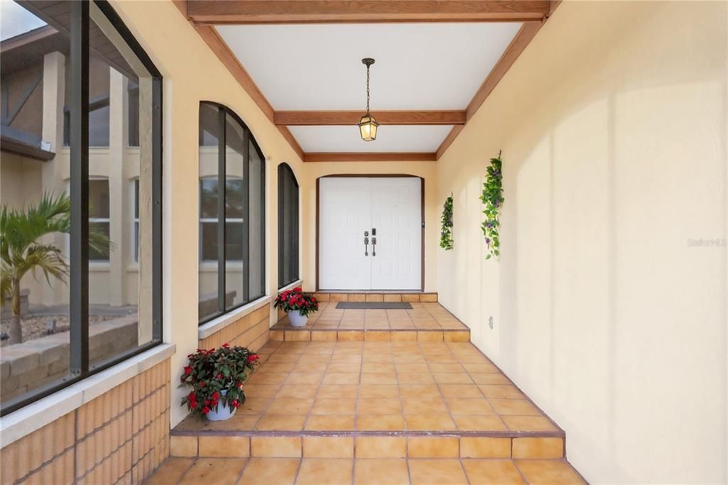 Screened-in front entryway with beautiful accents