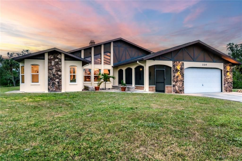 Front elevation showing the large windows, stone siding, and wood accents that really make this home stand out.