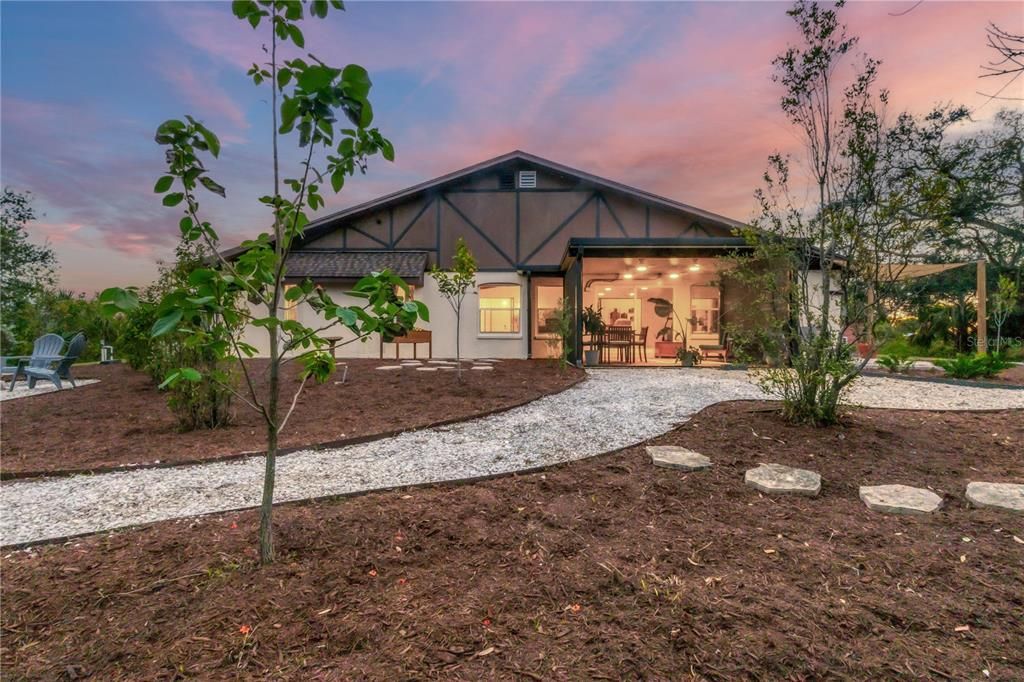 Rear elevation of the home showing the large screened-in lanai and elevation accents.