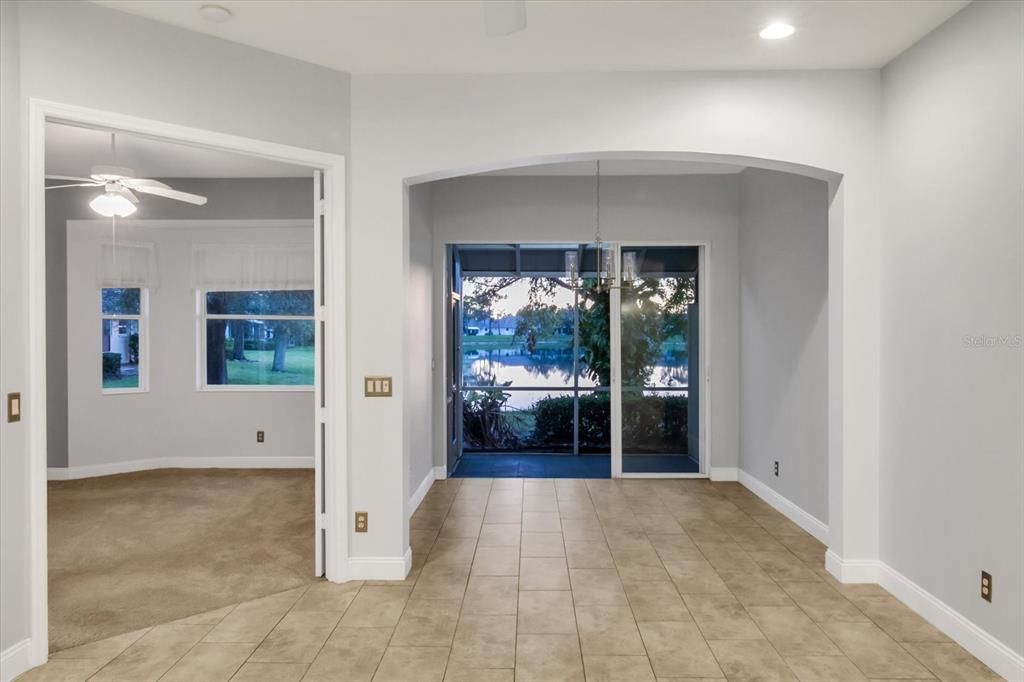 View of the dining room area, Lanai in the background & the Master bedroom entry on the left through the French doors.