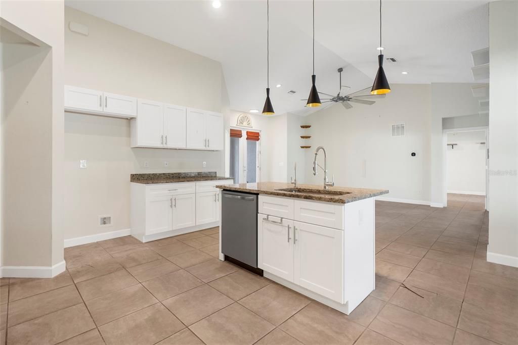 Modern kitchen with granite counter tops, stainless steel appliances, center island and plenty of cabinets.