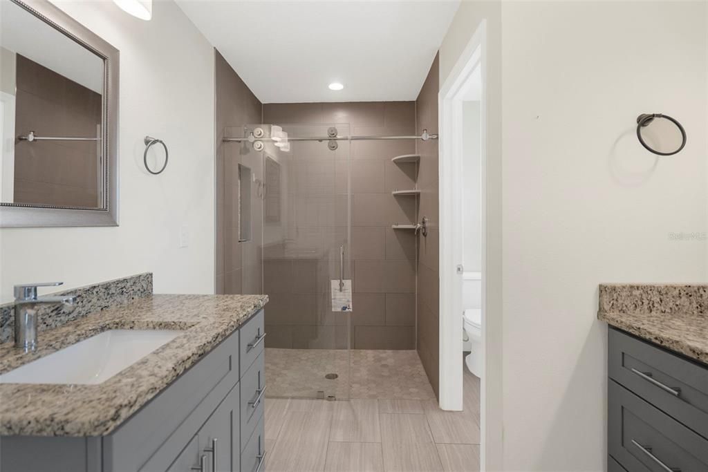 His and hers vanities. Walk-in tiled shower.