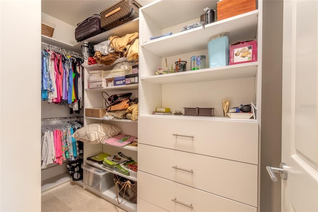 Primary bedroom's Custom walk in closet. There is a second closet with custom built ins too!