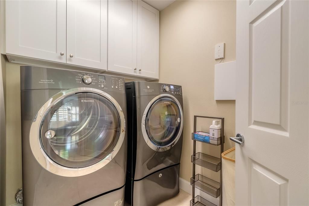 Laundry room with built in cabinets for lots of storage