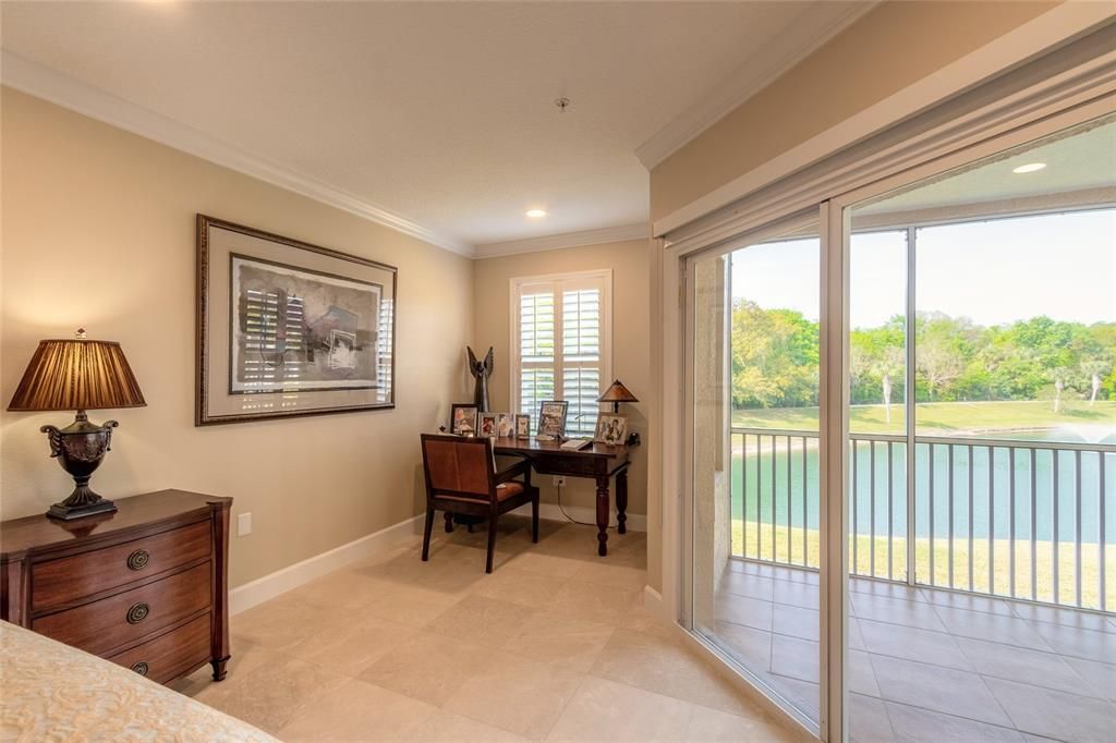 Beautiful water view from primary bedroom with sitting area