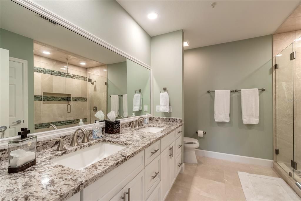 Primary bedroom's bathroom boast an enlarged shower with 2 shower heads & a rain shower head and beautiful accent tile